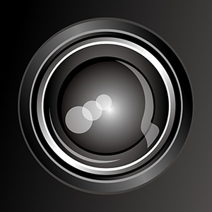Logo Scheewel Photo - In einer grauen Box stehende graue Linse einer Kamera.